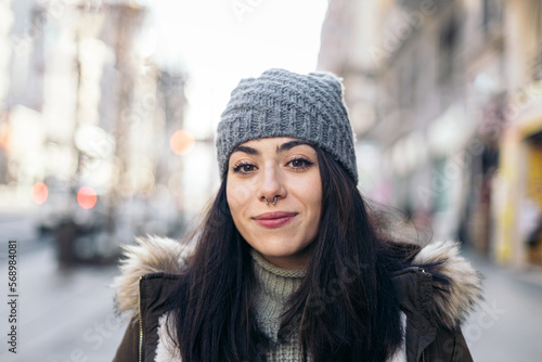 Portrait of a cheerful young woman in winter clothes