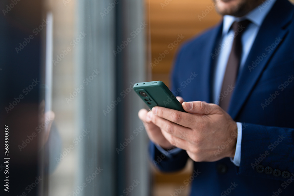 Close up view of businessman using smartphone, focus on phone Close up view of businessman using smartphone, focus on phone