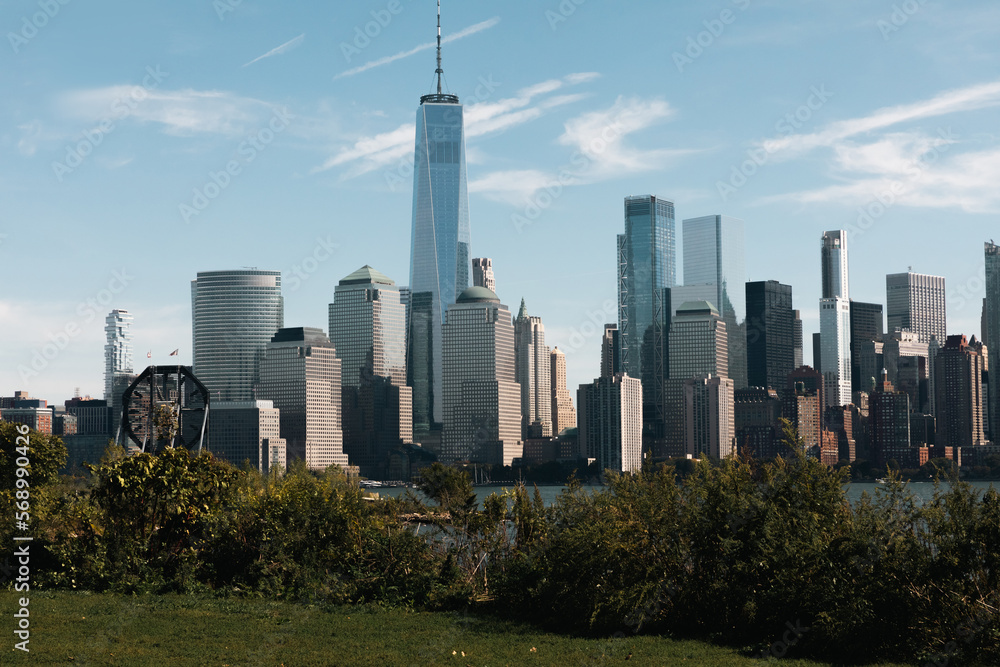 financial center of Manhattan with One World Trade Center near Hudson river and park in New York City.