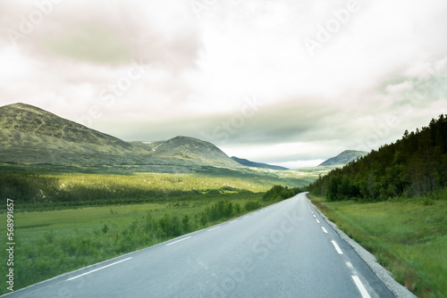 This road through the incredible landscape in Norway is beautiful photo