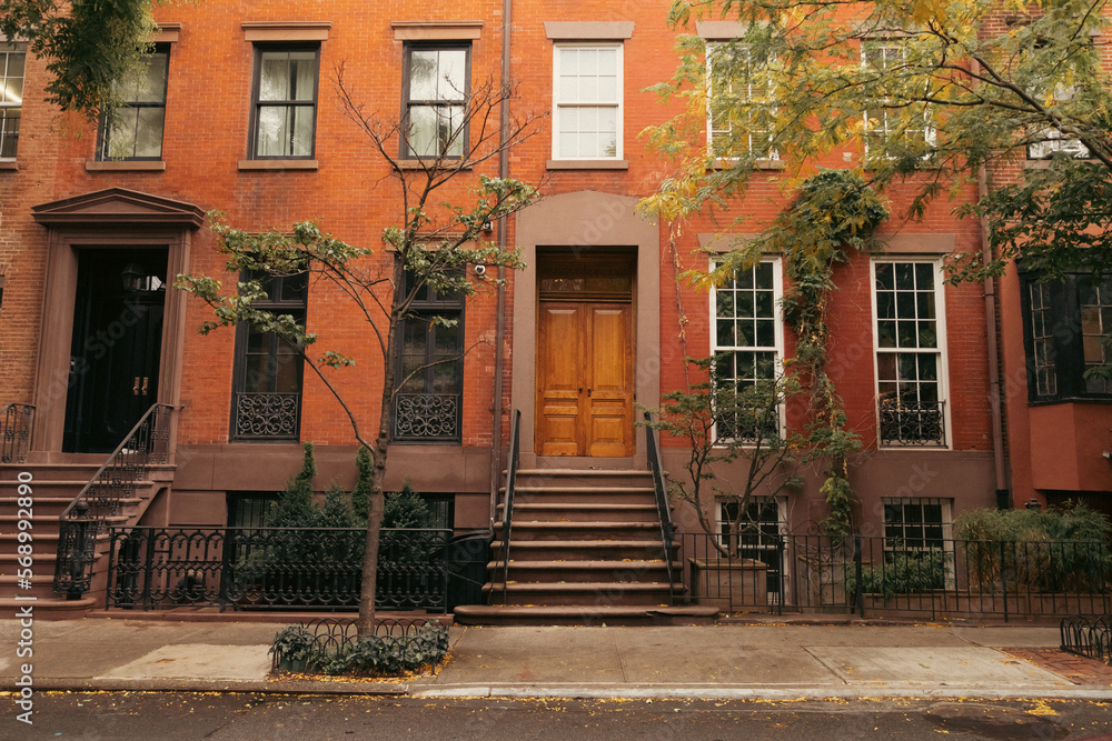 Facade of building with steps and doors on urban street in brooklyn heights in New York City.