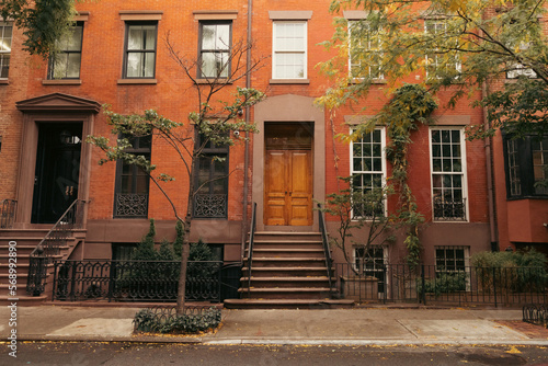 Facade of building with steps and doors on urban street in brooklyn heights in New York City.