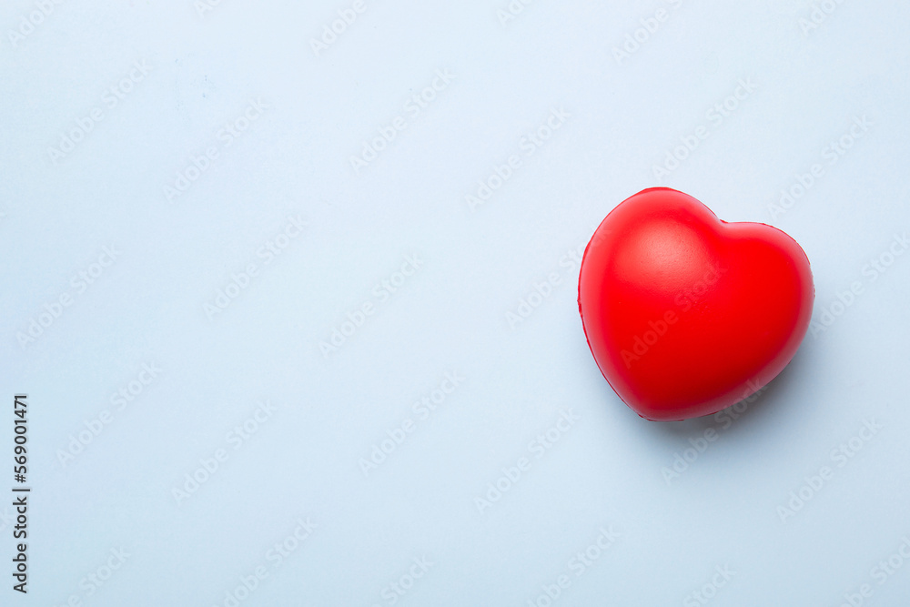 red heart shape on colored background. minimal concept top view with copy space