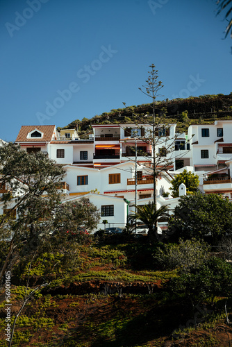 Tenerife Spain. Buildings in the city on the mountains. Roads and palm trees, incredible views of the sunny city. © MoreThanProd
