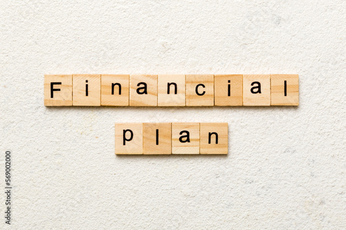 financial plan word written on wood block. financial plan text on cement table for your desing, concept