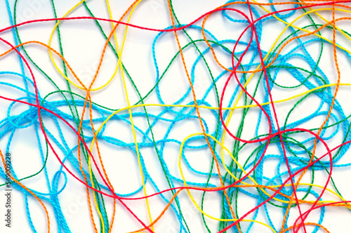 Tangled colorful threads on a white background
