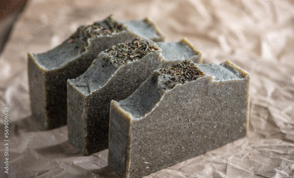 Natural herbal handmade soap on the background of craft paper. Concept of create and use organic eco soap and cosmetics Natural herbal handmade soap on the background of craft paper. Concept of create and use organic eco soap and cosmetics