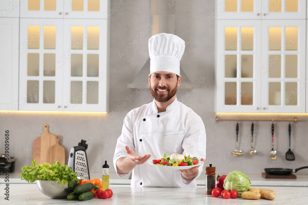 Professional chef presenting delicious salad at marble table in kitchen Professional chef presenting delicious salad at marble table in kitchen