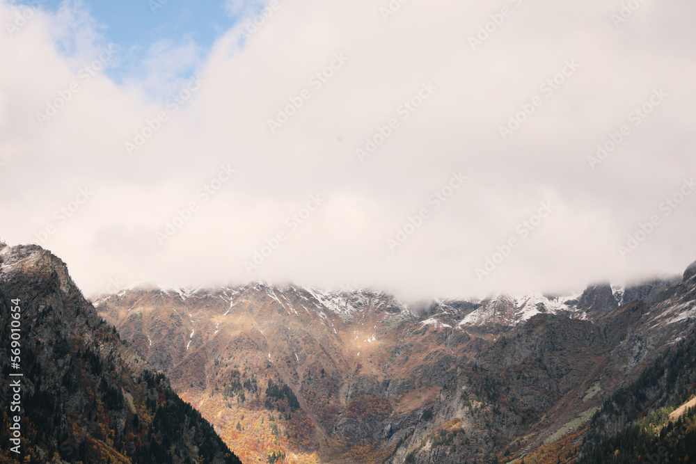 Picturesque landscape of high mountains under cloudy sky