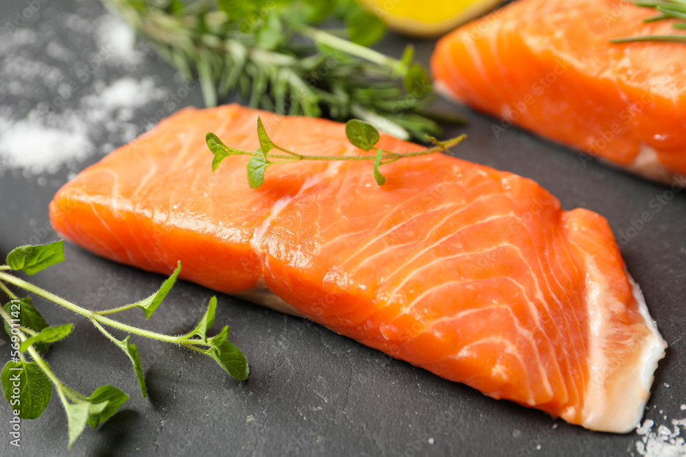 Fresh salmon and ingredients for marinade on black table, closeup Fresh salmon and ingredients for marinade on black table, closeup