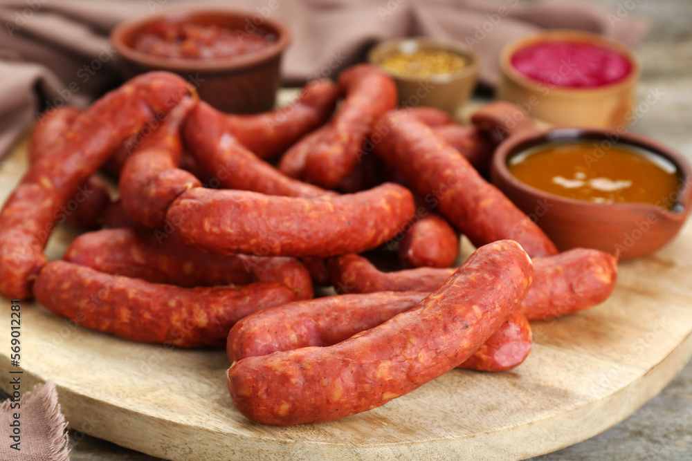 Delicious sausages, ketchup, mustard and horseradish on wooden table, closeup Delicious sausages, ketchup, mustard and horseradish on wooden table, closeup