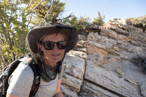 Woman Wearing Bug Net Enjoys Hiking without Flying Pests photo