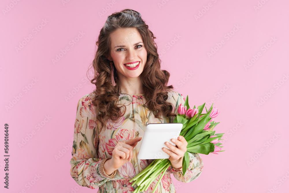 happy stylish 40 years old woman in floral dress on pink happy stylish 40 years old woman in floral dress on pink