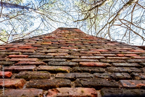 closeup of brick chimney from historic civil war era 1800s or 19th century southern log cabin in Callaway gardens in Georgia photo