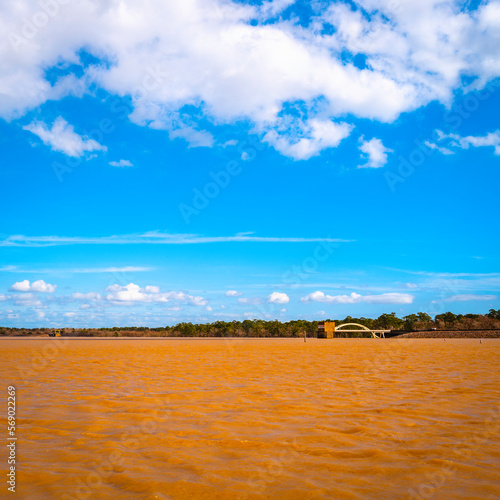 Lake Houston at Dwight D. Eisenhower Park in Texas with dramatic cloudscape over the red muddy water photo