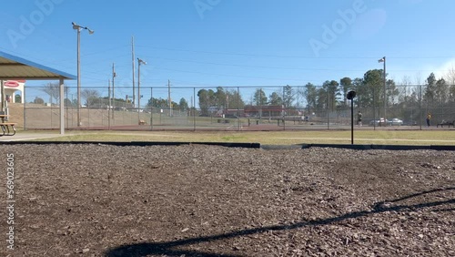 People playing tennis and basketball in the distance clear blue sky at park Goodale in Grovetown Georgia photo