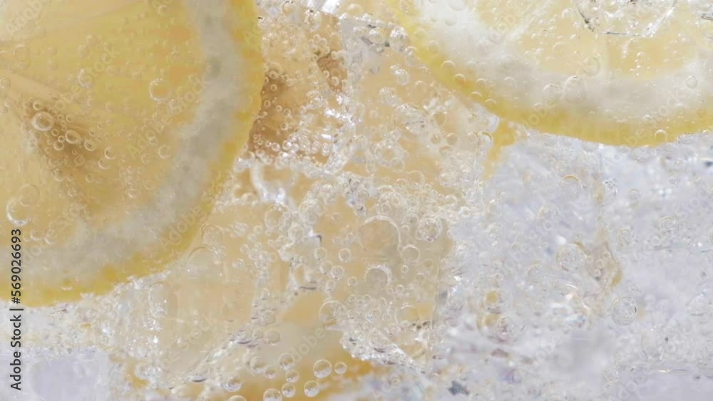 Soda water with ice cubes and sliced lemon slow motion video. Soda water with ice cubes and sliced lemon slow motion video.