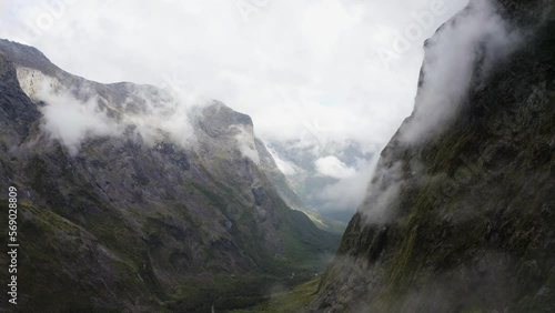 Winding road passing thru the mountains, fog, and clouds in Milford Sound New Zealand on the South Island. 