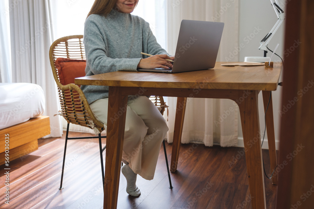 Closeup image of a young woman working on laptop computer at home Closeup image of a young woman working on laptop computer at home