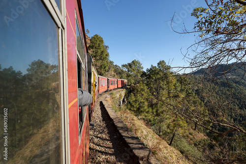 Toy train running from Kalka to Shimla or Simla capital of Himachal Pradesh north India Himalayas. Indian mountain railway	 photo