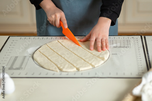Murais de parede Using the kitchen silicone baking mat with markings and tips in the process of cooking in the kitchen with copy space