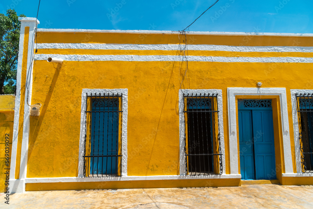 Yellow facade of a house in a country town in Colombia.