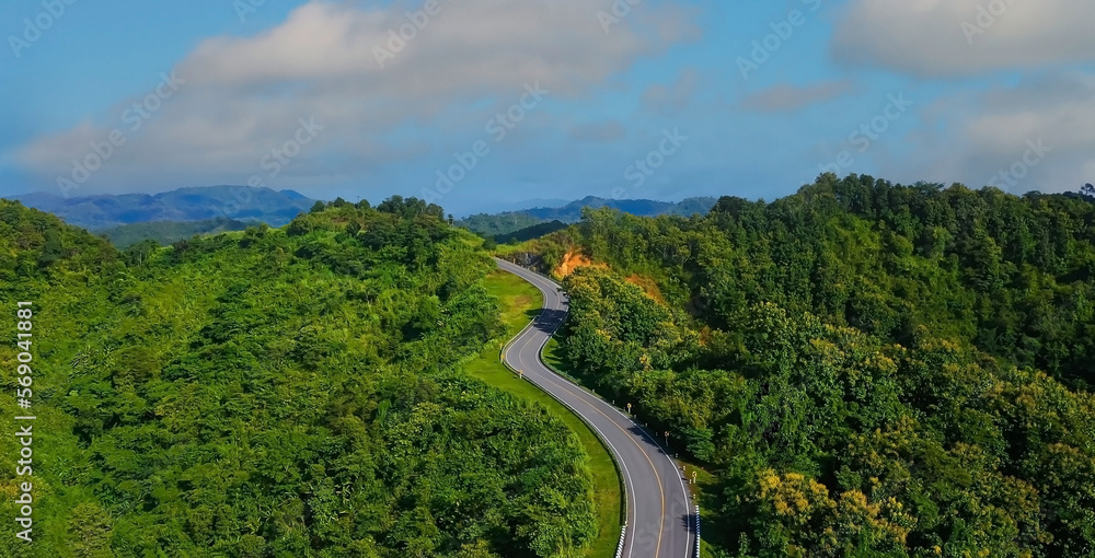 The highway stairs to the sky of road trough with green nature forest  as the natural landscape background