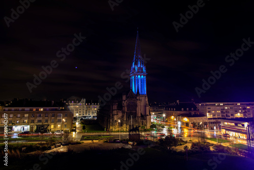 Saint Peters Catholic Church at night with view of the city of Caen, France, Europe. 