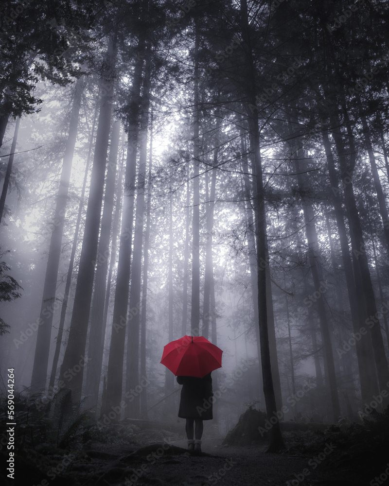 girl standing with red umbrella in the forest
