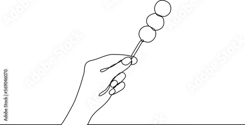 Hand holding dango