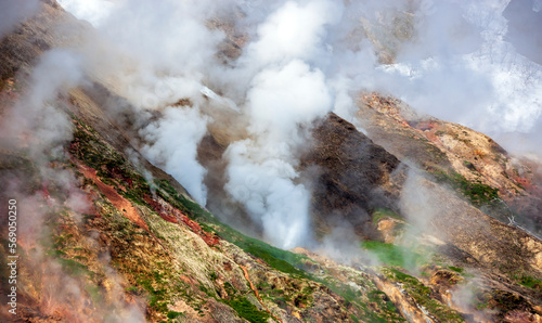 Geyser landscape with emissions of steam, gases and hot water in the country of volcanoes on the Kamchatka Peninsula.