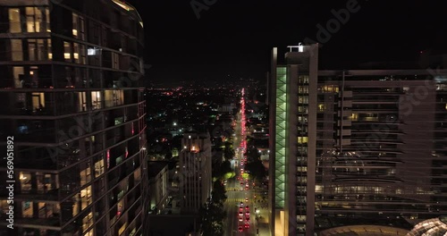 San Jose California Aerial v8 fly straight above santa clara street in between high rise buildings capturing shimmering glass window and horace mann neighborhood - Shot with Mavic 3 Cine - June 2022 photo