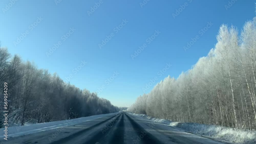 Driving a car on a winter road through a snow-covered forest. Beautiful and dangerous driving on a winter road. Driving a car on a winter road through a snow-covered forest. Beautiful and dangerous driving on a winter road.