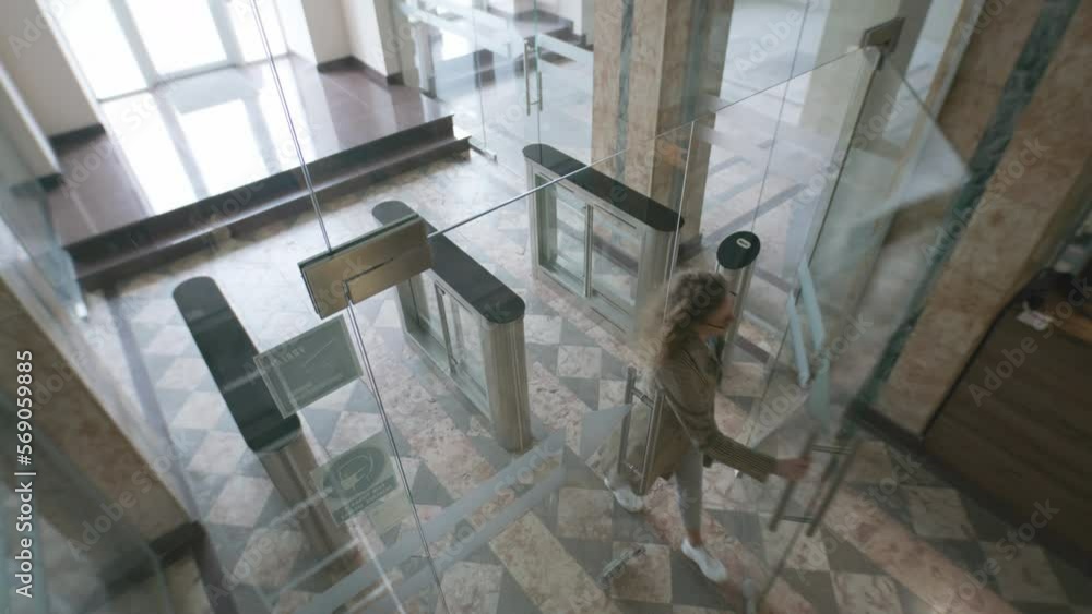 View from security cameras at the exit in the hotel or business center office. People or workers enter and exit through glass doors and turnstile. Concept of tracking system, monitoring and safety. View from security cameras at the exit in the hotel or business center office. People or workers enter and exit through glass doors and turnstile. Concept of tracking system, monitoring and safety.