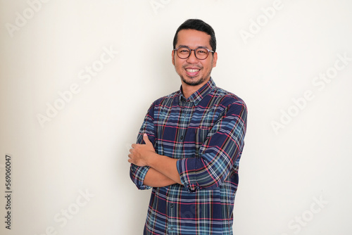 Adult Asian man smiling confident with arms crossed
