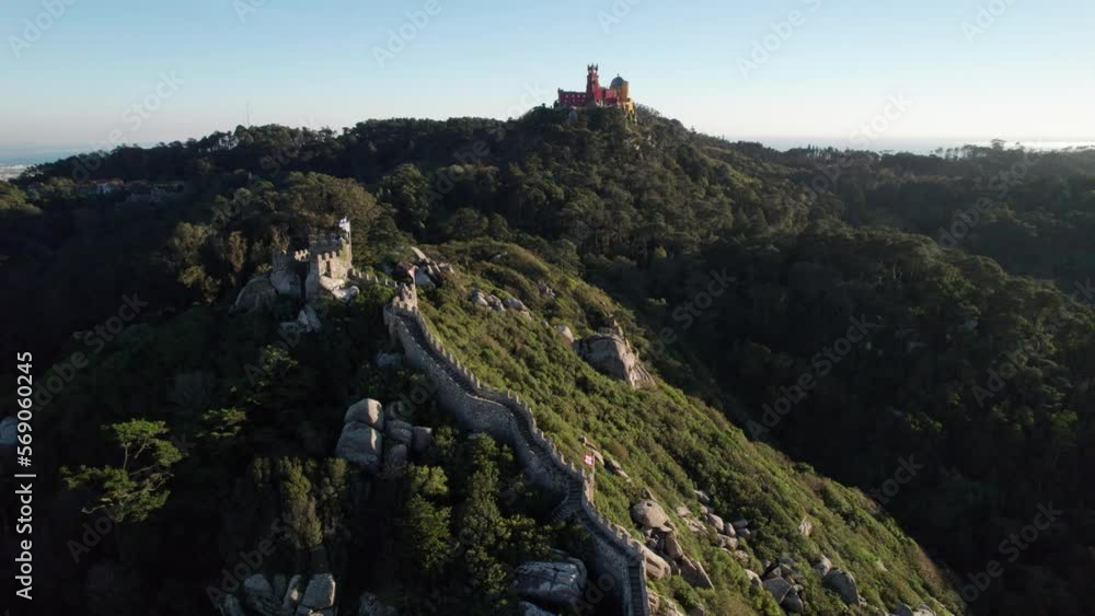 aerial view of the Castle of the Moors (Castelo dos Mouros, castelo da pena) illuminated by sunlight standing on the top of the hill in central Portugal above the town of Sintra, Lisbon, Portugal. aerial view of the Castle of the Moors (Castelo dos Mouros, castelo da pena) illuminated by sunlight standing on the top of the hill in central Portugal above the town of Sintra, Lisbon, Portugal.