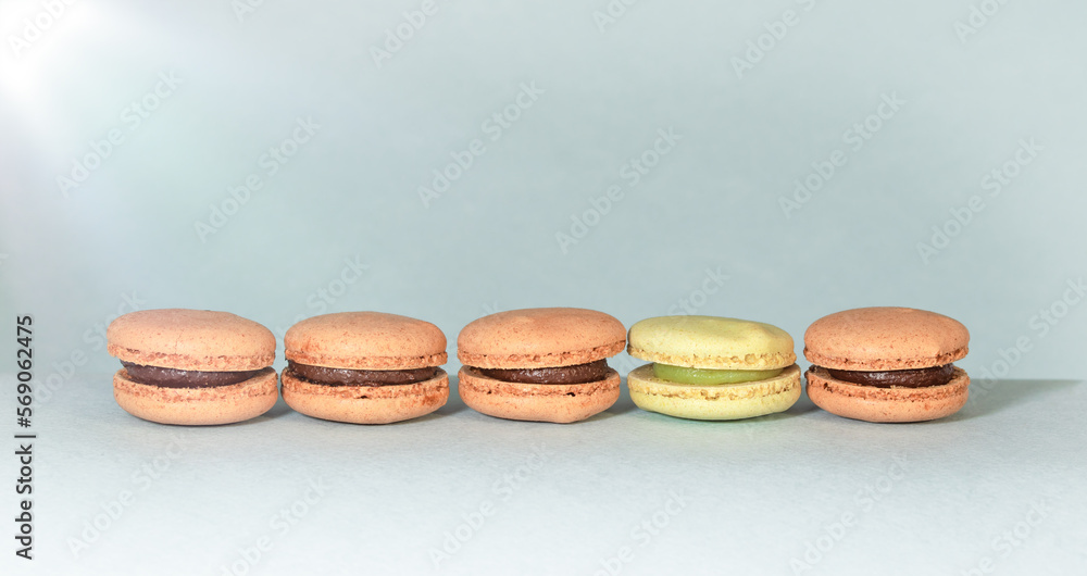 Cake macaron or macaroon on turquoise background, pastel colors, vintage card, top view Cake macaron or macaroon on turquoise background, pastel colors, vintage card, top view