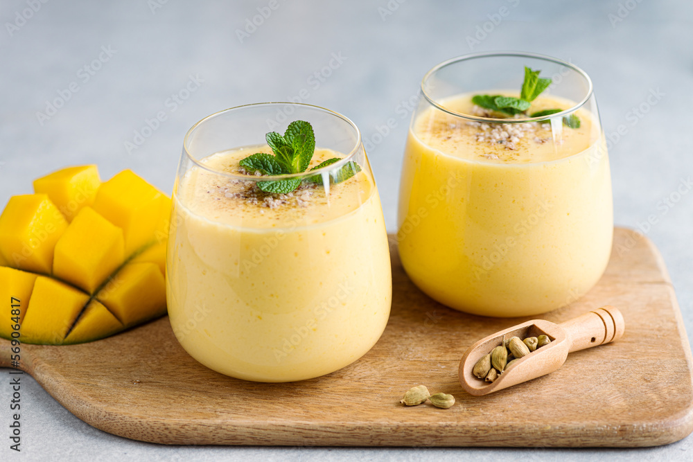 Lassi mango, traditional indian drink on the serving board, selective focus Lassi mango, traditional indian drink on the serving board, selective focus