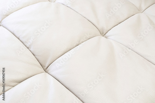 White leather texture. Part of perforated leather details. Orange perforated leather texture background. Texture, artificial leather with diagonal stitching.