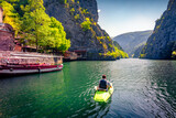 Tourist kayaking on the Matka Canyon. Majestic morning scene of North Macedonia, Europe. Traveling concept background.