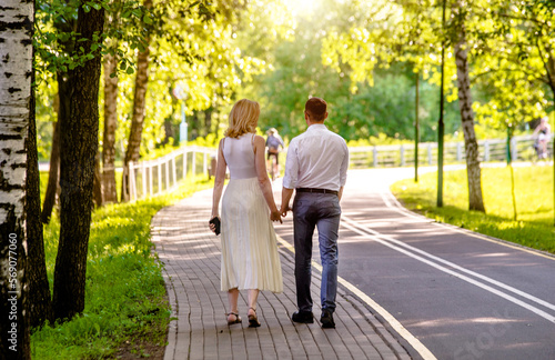 A guy and a girl walk along the path in the city Park  © licvin