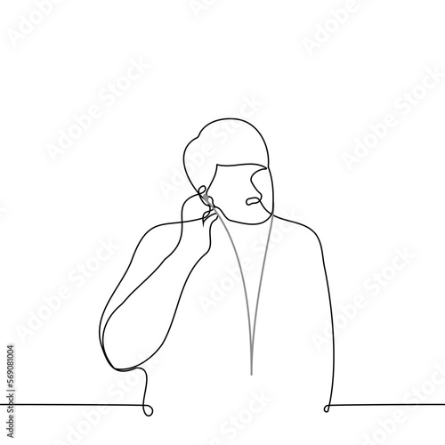 man inserting a wired earpiece into his ear - one line drawing vector. concept lover of wired headphones