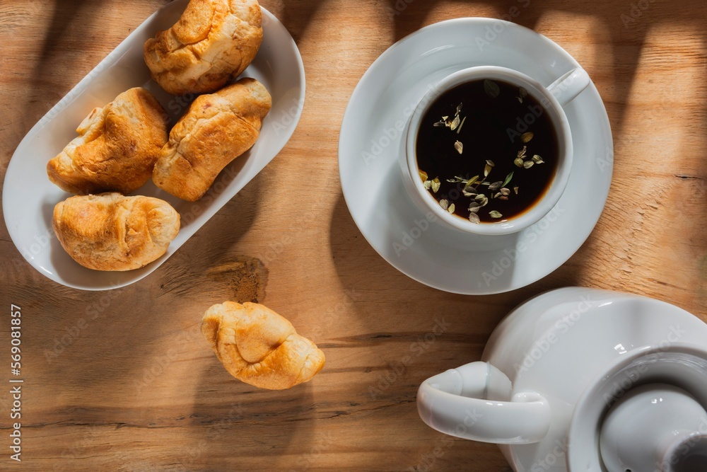 Morning breakfast - tea and light snack on a background dark Morning breakfast - tea and light snack on a background dark