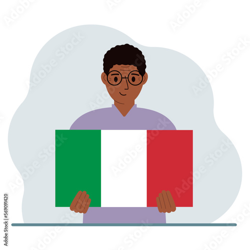 A man holds an Italian flag in his hands. The concept of demonstration, national holiday or patriotism.