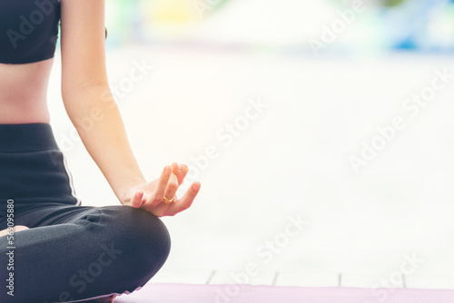 Yoga fitness lifestyle healthy woman relaxation doing a meditation. Yoga meditate outdoor with zen on sitting position. Yoga woman workout in sportswear sit on yoga mat home fitness workout exercise