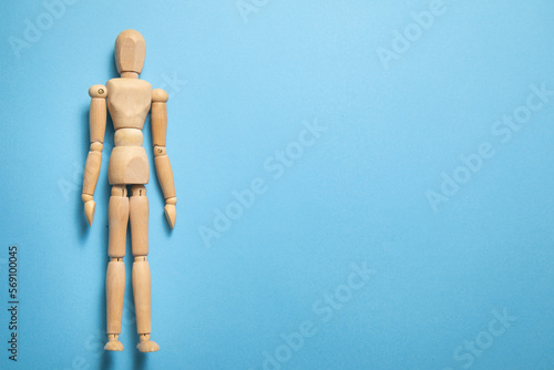 Wooden human figure on the blue background.