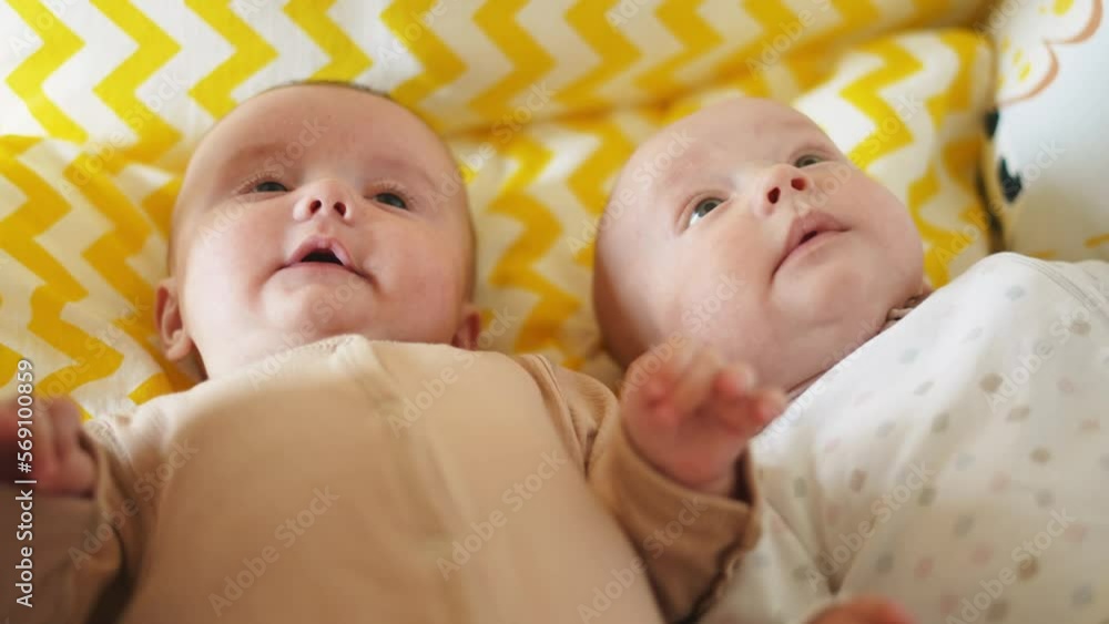 two twins lie in a bed. happy family kid dream concept. cute twins lie