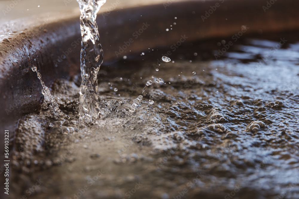 Pool in field with water. Little plunge pool with water preparing for customers. Close-up of splashes Pool in field with water. Little plunge pool with water preparing for customers. Close-up of splashes