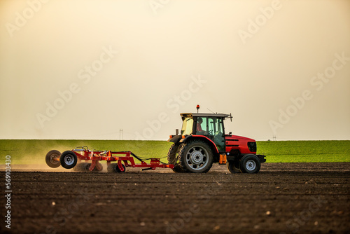 Fotografie A farmer's labor of love, tractor tilling the soil for a prosperous harvest