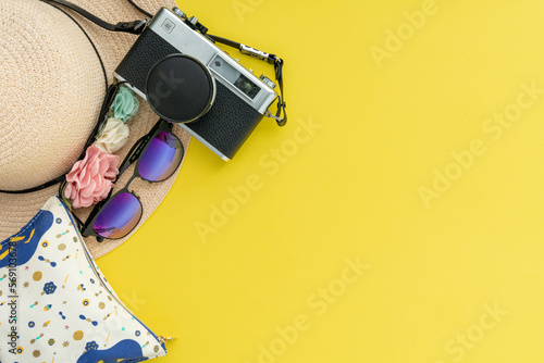 Composition with beach accessories and space for text on yellow background. Summer vacation, holiday, trip and travel concept. Flat lay, banner design 